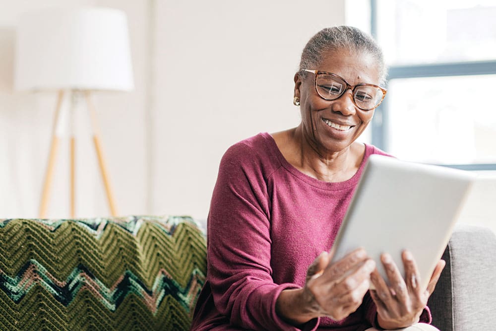 Senior Aged Woman with Tablet Filling out Aging Choices Checklist